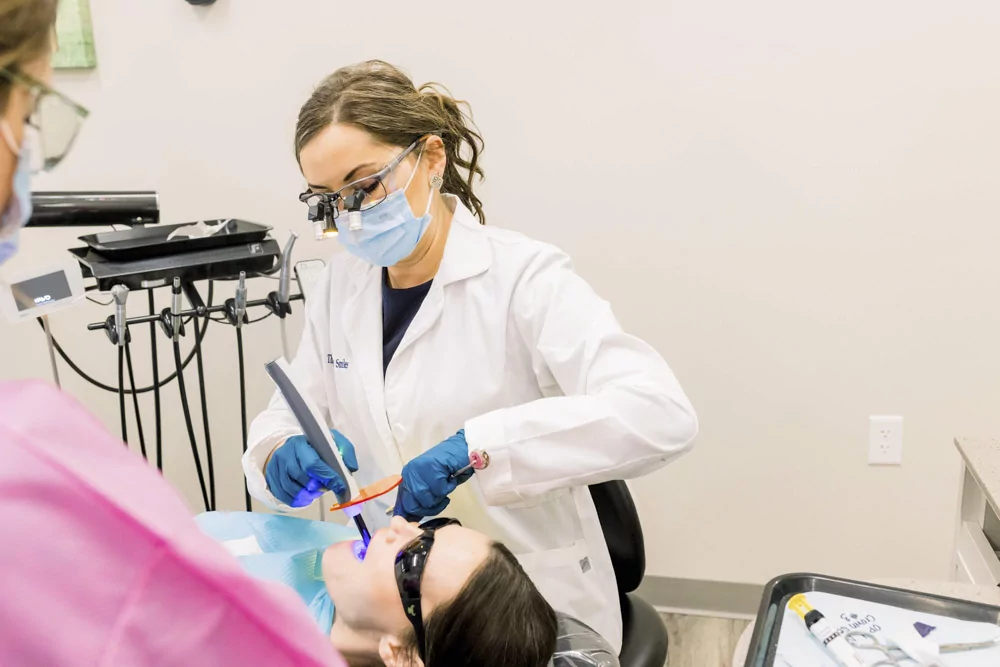 Dr. Neda whitening a patients teeth