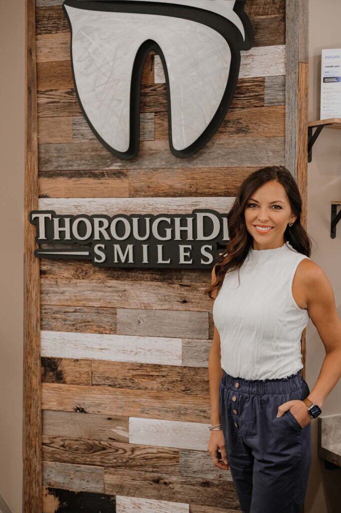 image of Dr. neda standing beside the logo of thoroughdent smiles