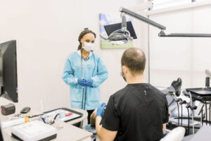 dr smith talking with a dental assistant and patient