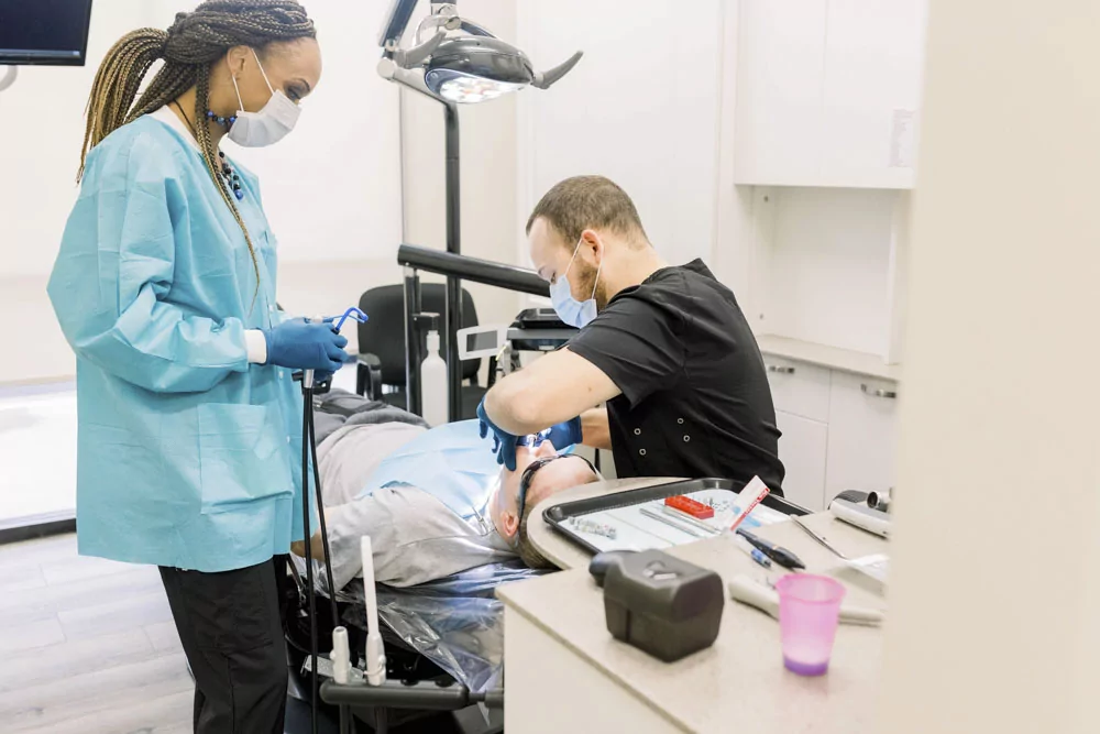 dr smith working on patient in dental chair